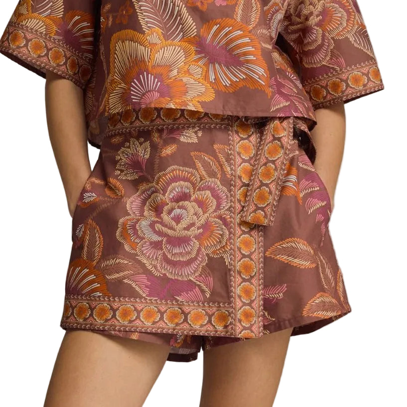 Woman wearing a patterned outfit on a gray background