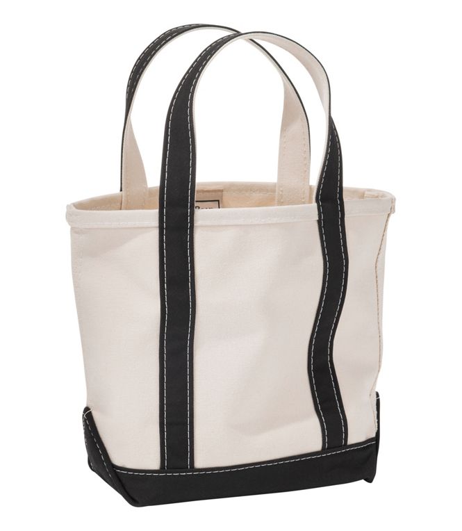 White tote bag with black straps and trim on a white background