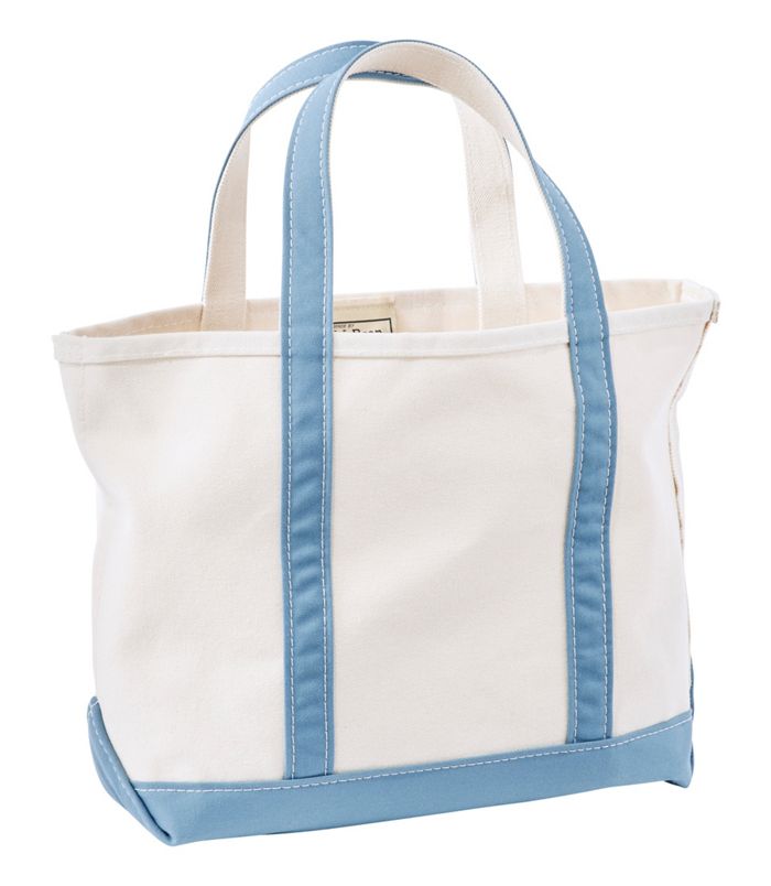 White tote bag with blue handles and trim on a white background
