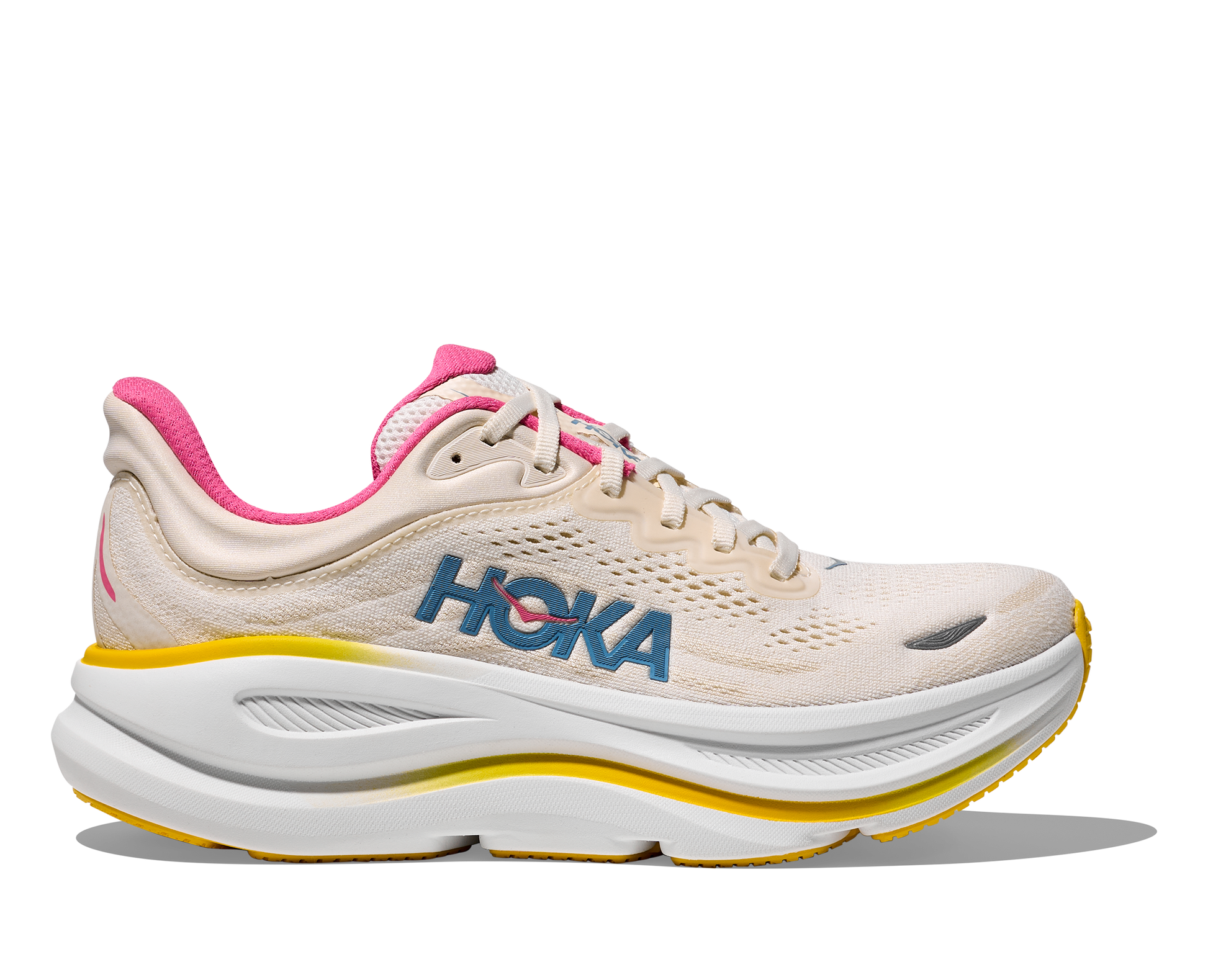 Beige running shoe with pink accents and 'Hoka' branding on a white background