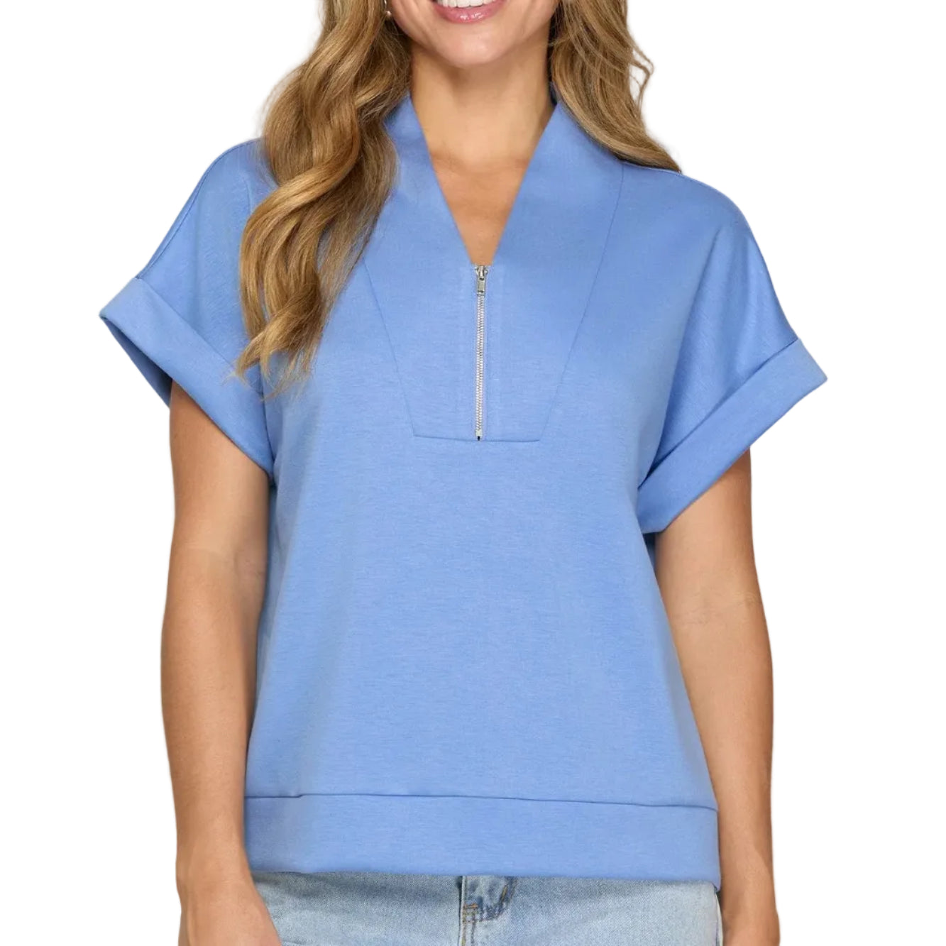 Woman wearing a blue short-sleeve top with a zipper on a plain background