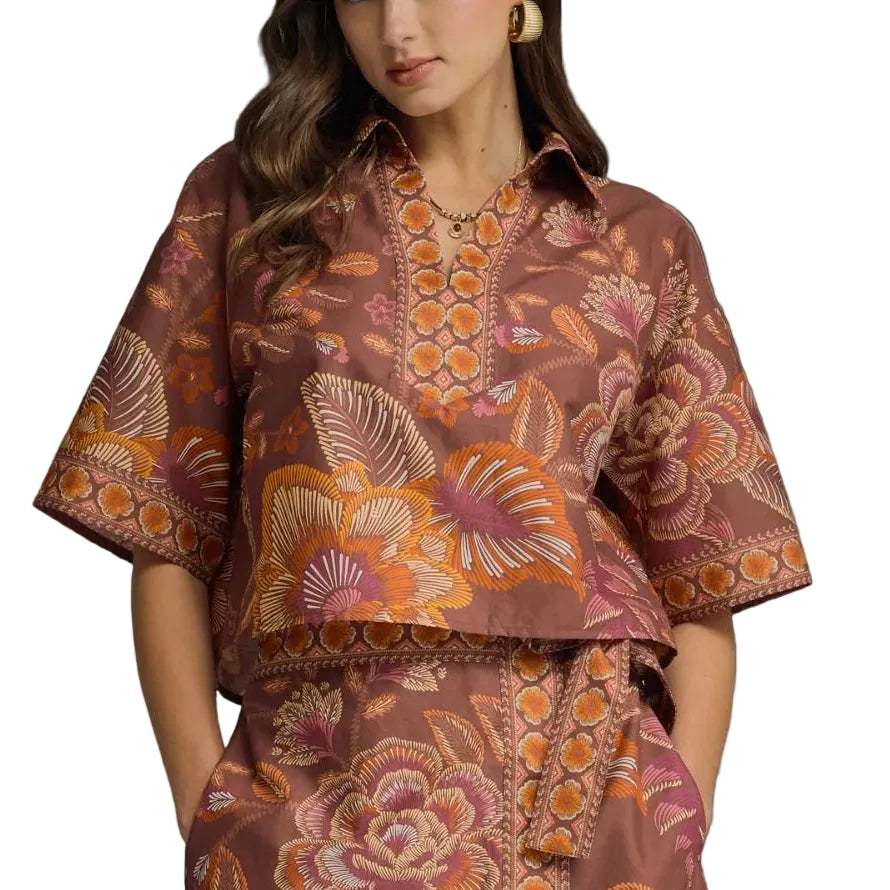 Woman wearing a patterned outfit on a gray background