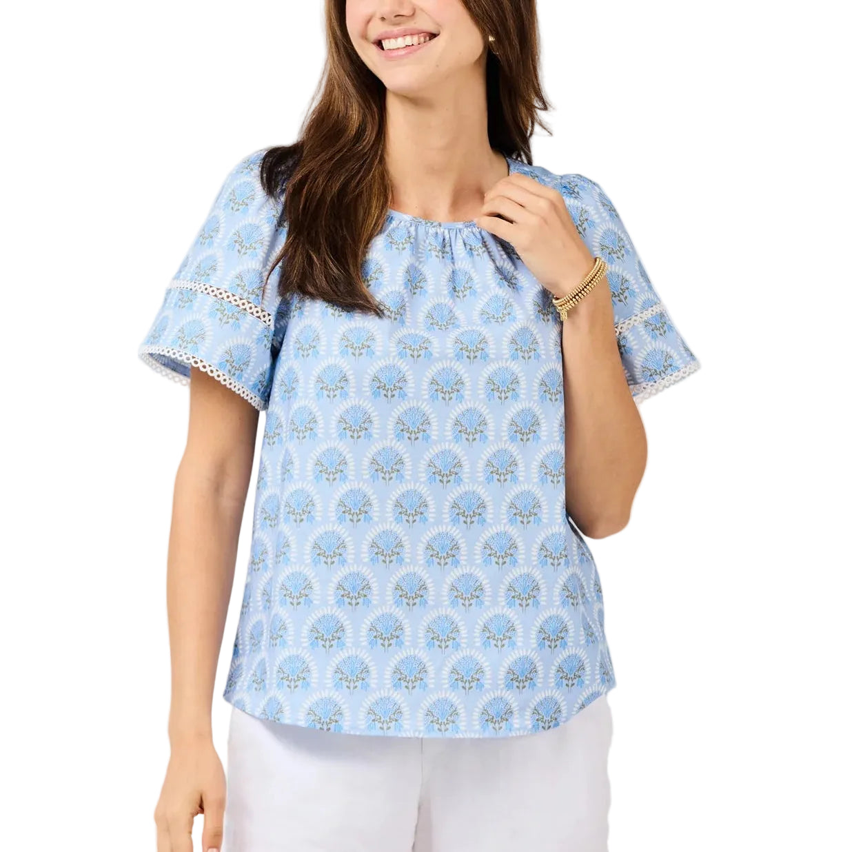 Woman wearing a light blue blouse with a subtle pattern on a white background