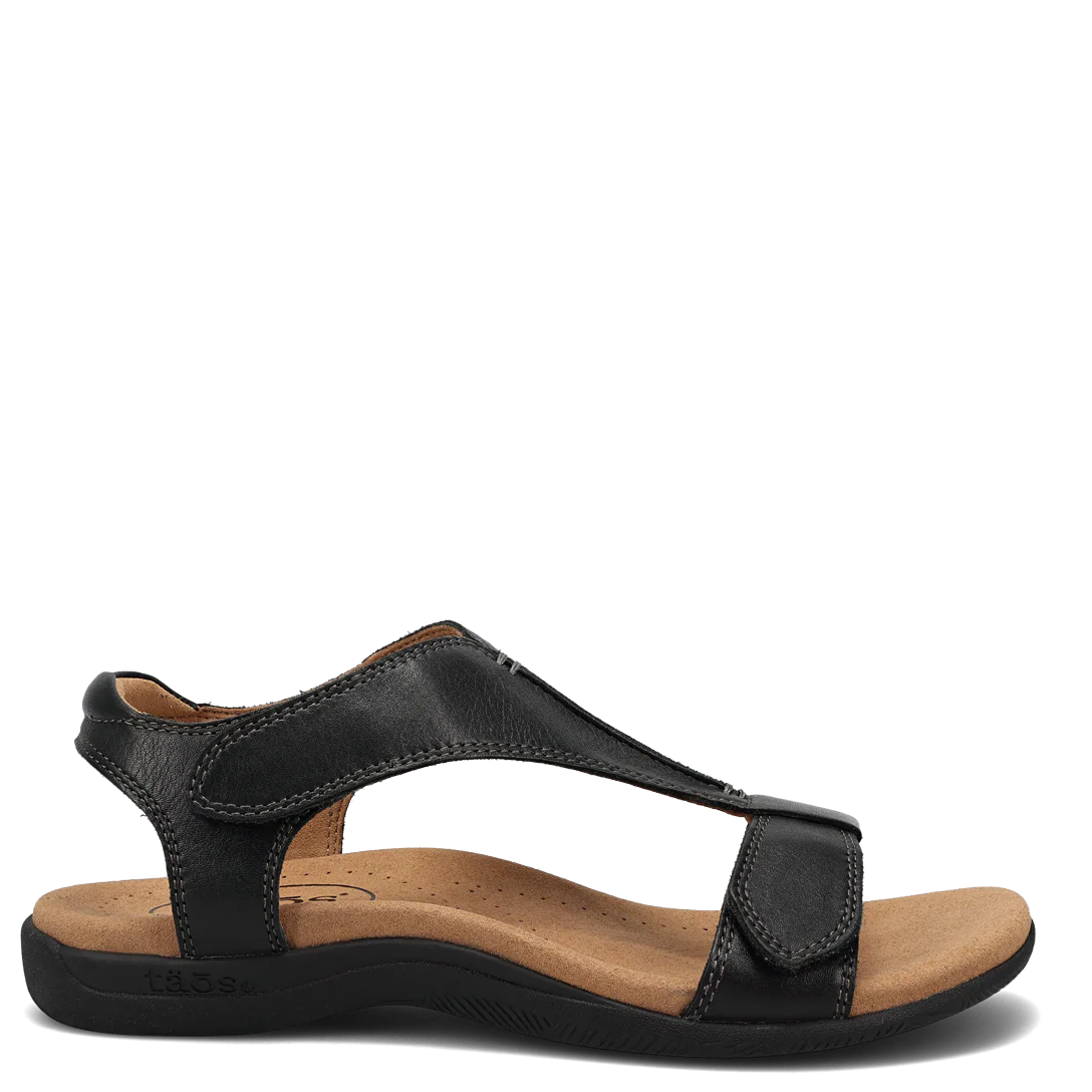 Black sandal with a brown sole on a white background