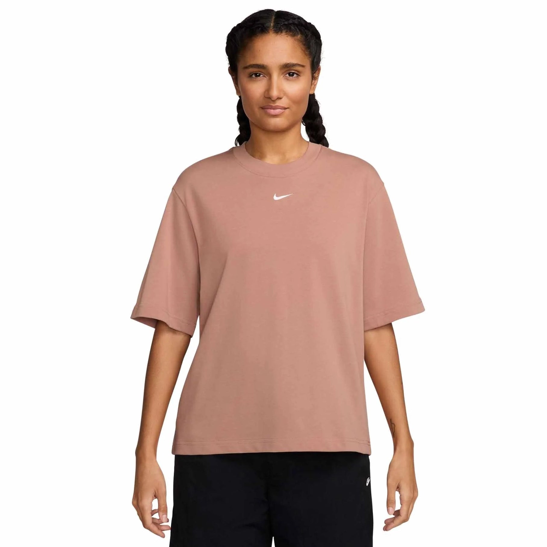 Person wearing a pink Nike t-shirt on a white background