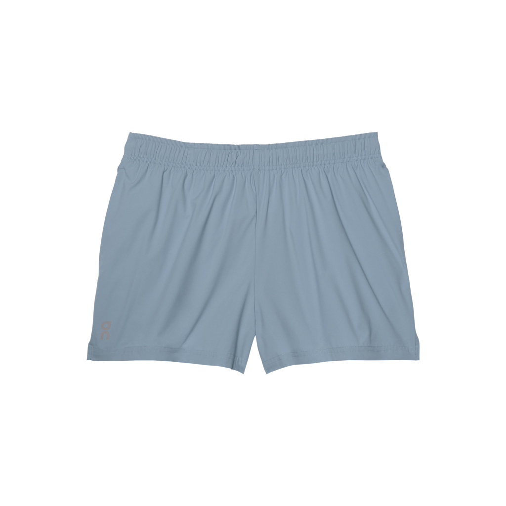 A pair of women's blue running shorts with an elastic waistband, side slits, and three pockets.