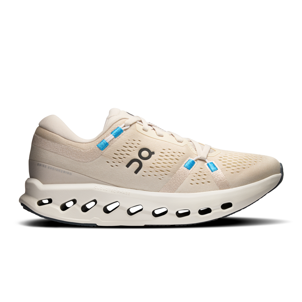 Beige running shoe with blue accents on a white background