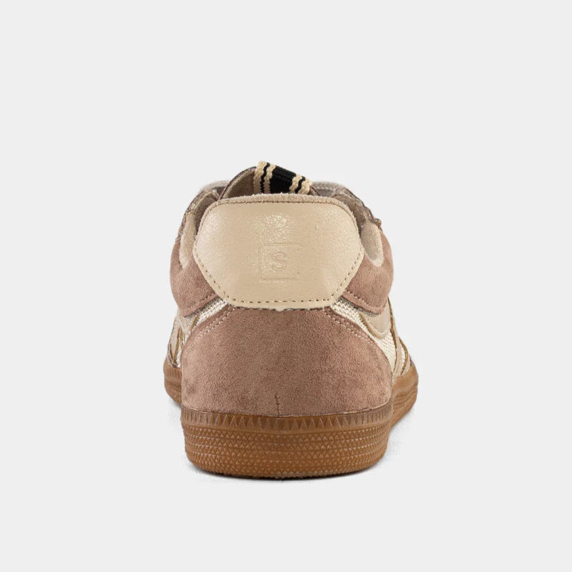 Brown sneaker with a white sole on a light gray background