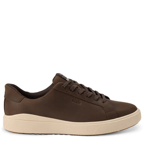 Brown sneaker with beige sole on a white background