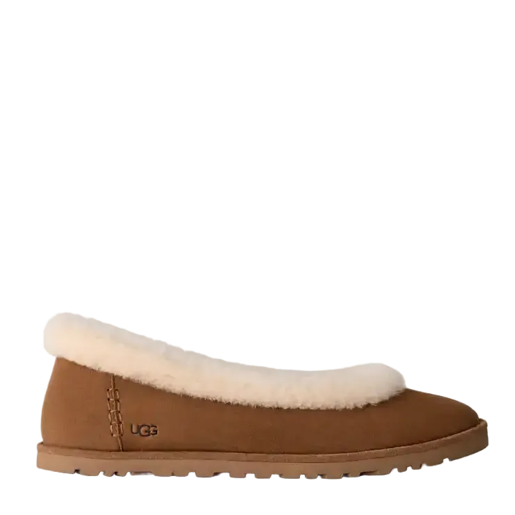 A single brown suede slipper with a thick cream shearling lining, shown in a side profile on a light off-white background. The UGG logo is visible on the side of the heel.