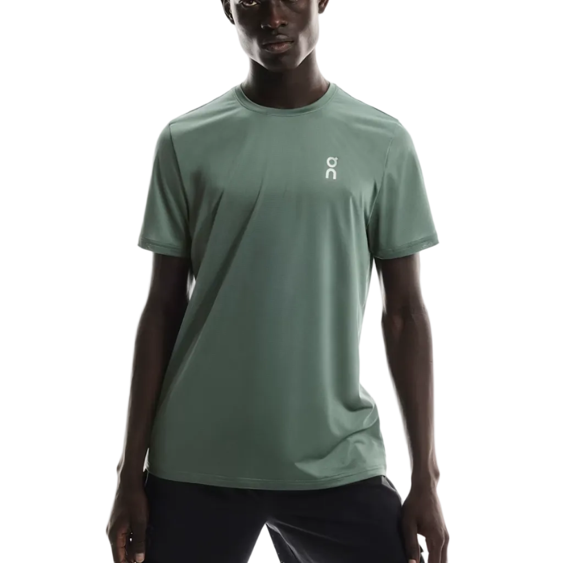 Person wearing a light green t-shirt with a logo on a white background