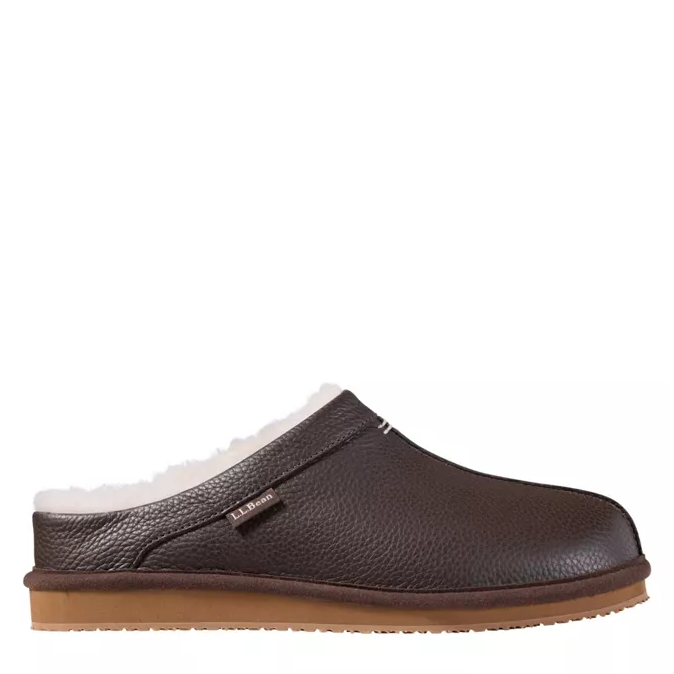 A dark brown pebbled leather slip-on clog shoe with a white shearling lining and a tan sole, shown from a side profile on a white background.