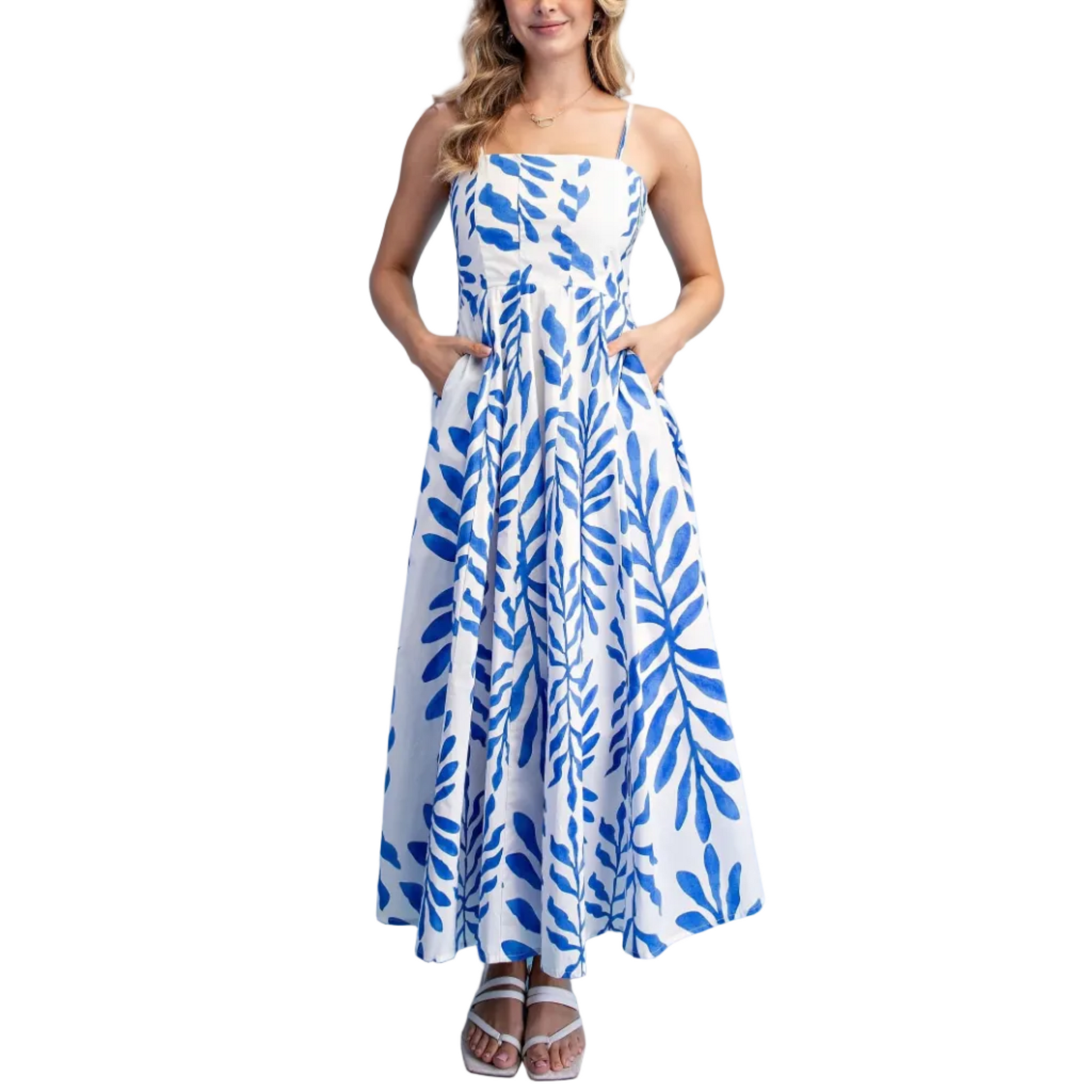 Woman wearing a blue and white patterned dress against a light blue background