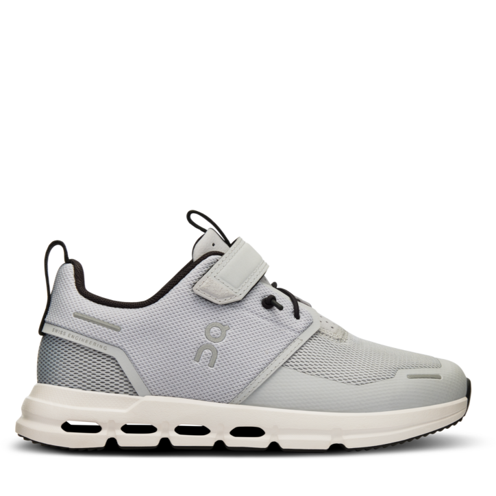 A grey and white On running sneaker designed for kids, featuring a hook and loop closure and a flat sole.