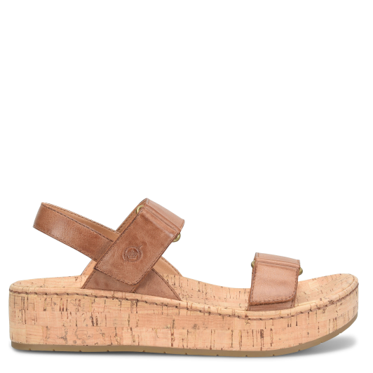 A brown women's sandal with adjustable straps and a cork-covered wedge heel.