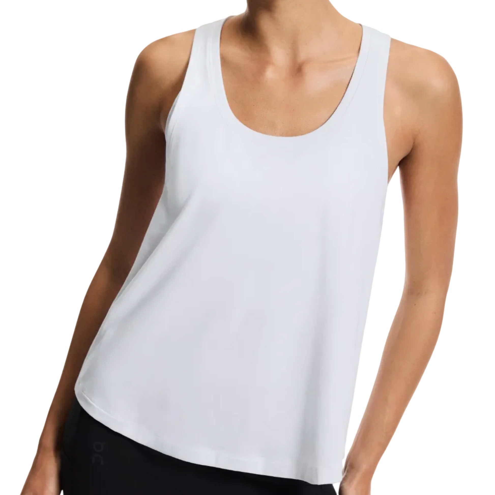 Woman wearing a white tank top on a plain background