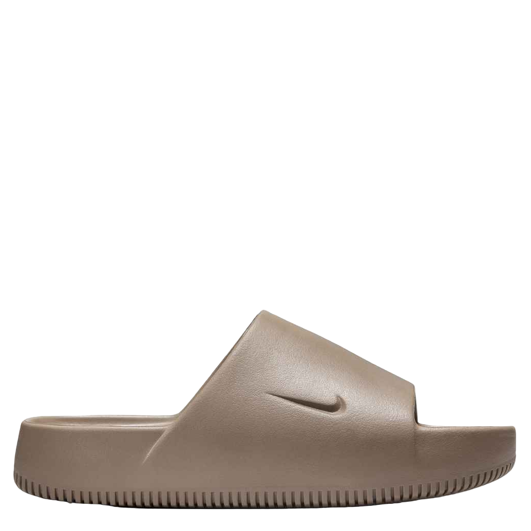 Beige slide sandal with Nike logo on a white background