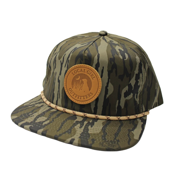 A rope hat with a Mossy Oak Bottomland camo print, featuring a round leather patch that says 'LOCAL GIRL OUTFITTERS' 