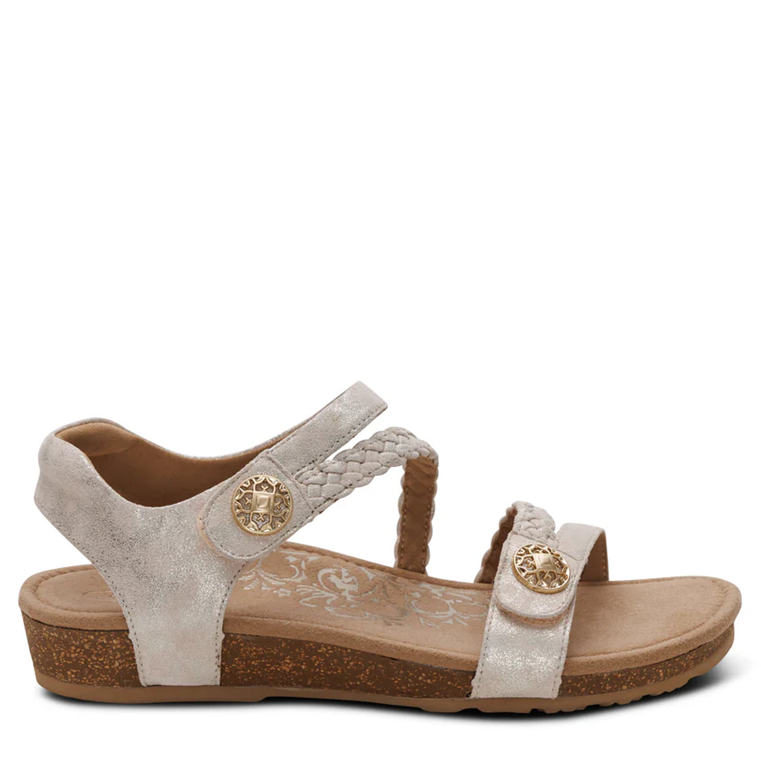 Beige sandal with brown sole on a white background