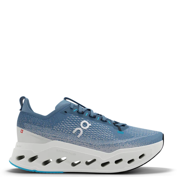 Blue running shoe with white sole on a white background