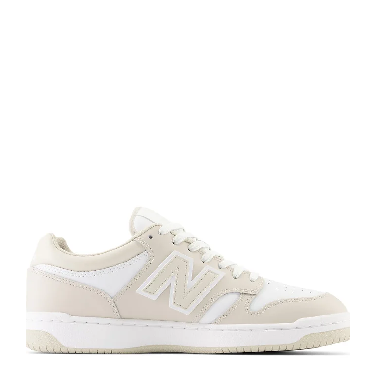 A pair of beige and white New Balance 480 sneakers with lace-up closure.