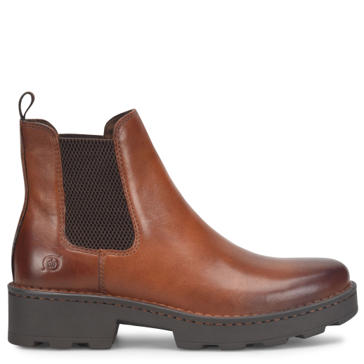 Brown leather Chelsea boot with a black sole on a white background