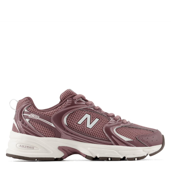 A New Balance sneaker in a dusty mauve-brown colorway, featuring a white midsole and a metallic silver 'N' logo on the side, shown against a plain white background.