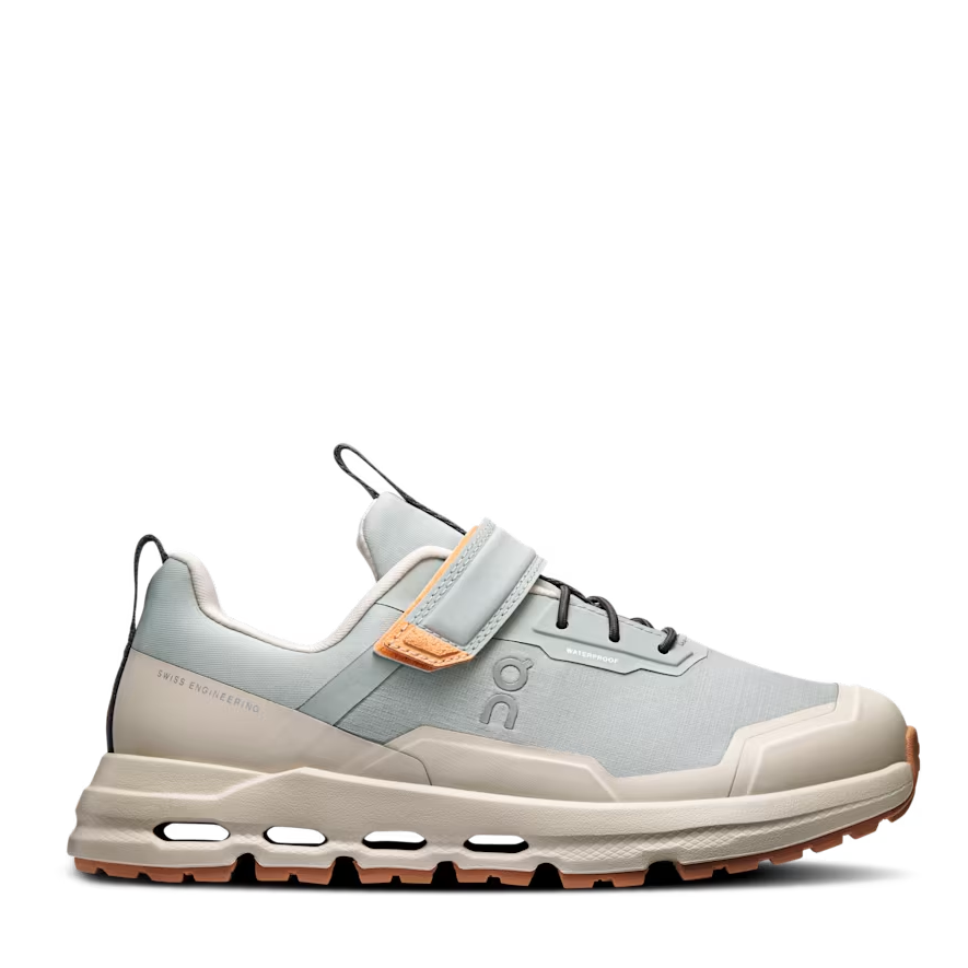 Light gray athletic shoe with orange accents on a white background