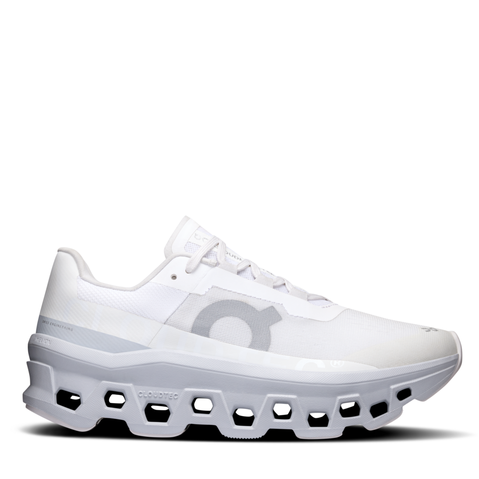 A pair of white women's running shoes with a unique cushioning system and a unique rocker shape for forward momentum.