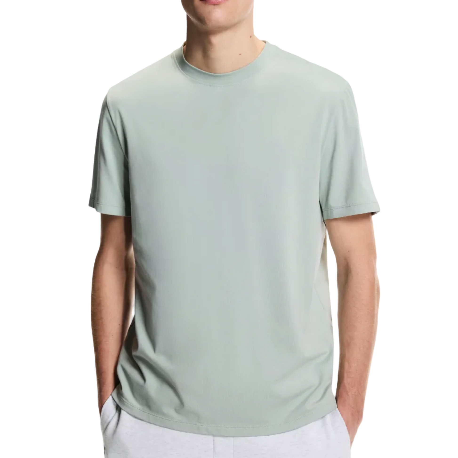Man wearing a light green t-shirt on a white background