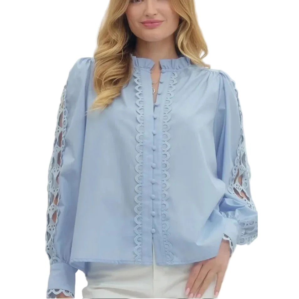 Woman wearing a light blue blouse with lace details on a white background