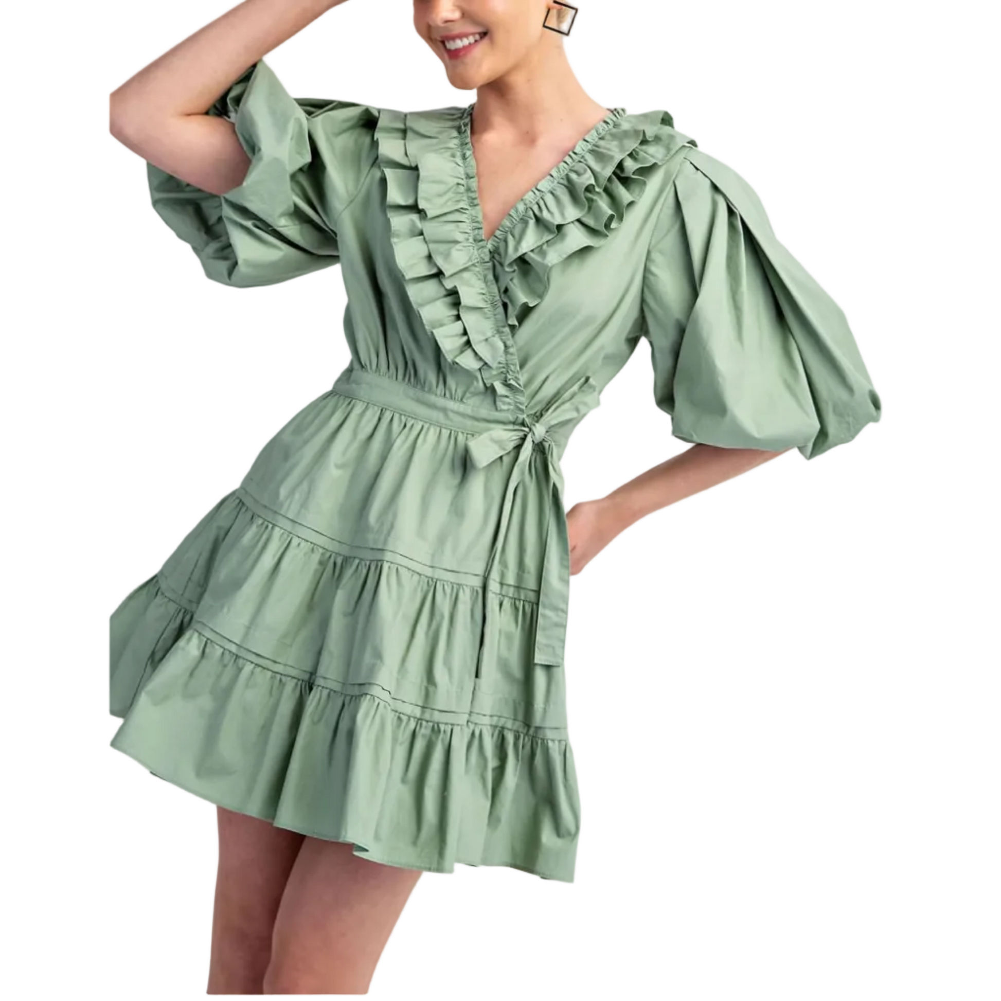 Woman wearing a green dress with ruffled details on a white background