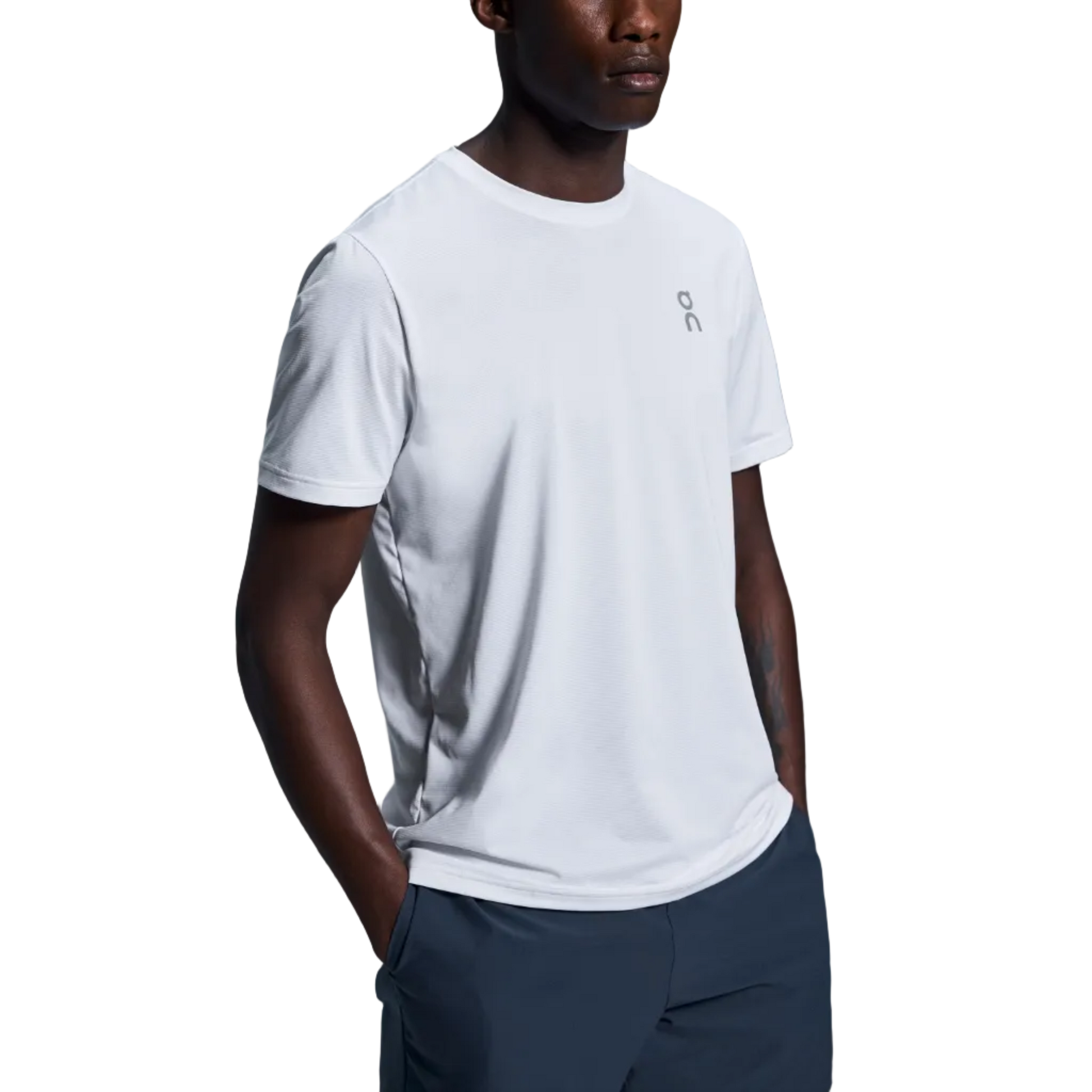 Man wearing a white t-shirt and navy shorts with a logo on a gray background