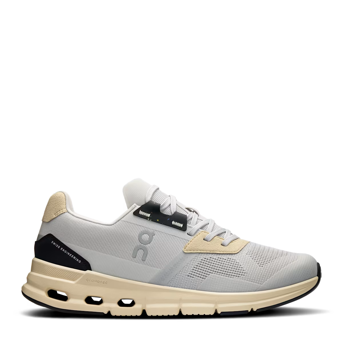 A pair of women's running shoes with a beige mesh upper and a white CloudTec sole, featuring a low-top design with a lace-up closure and a logo on the side.