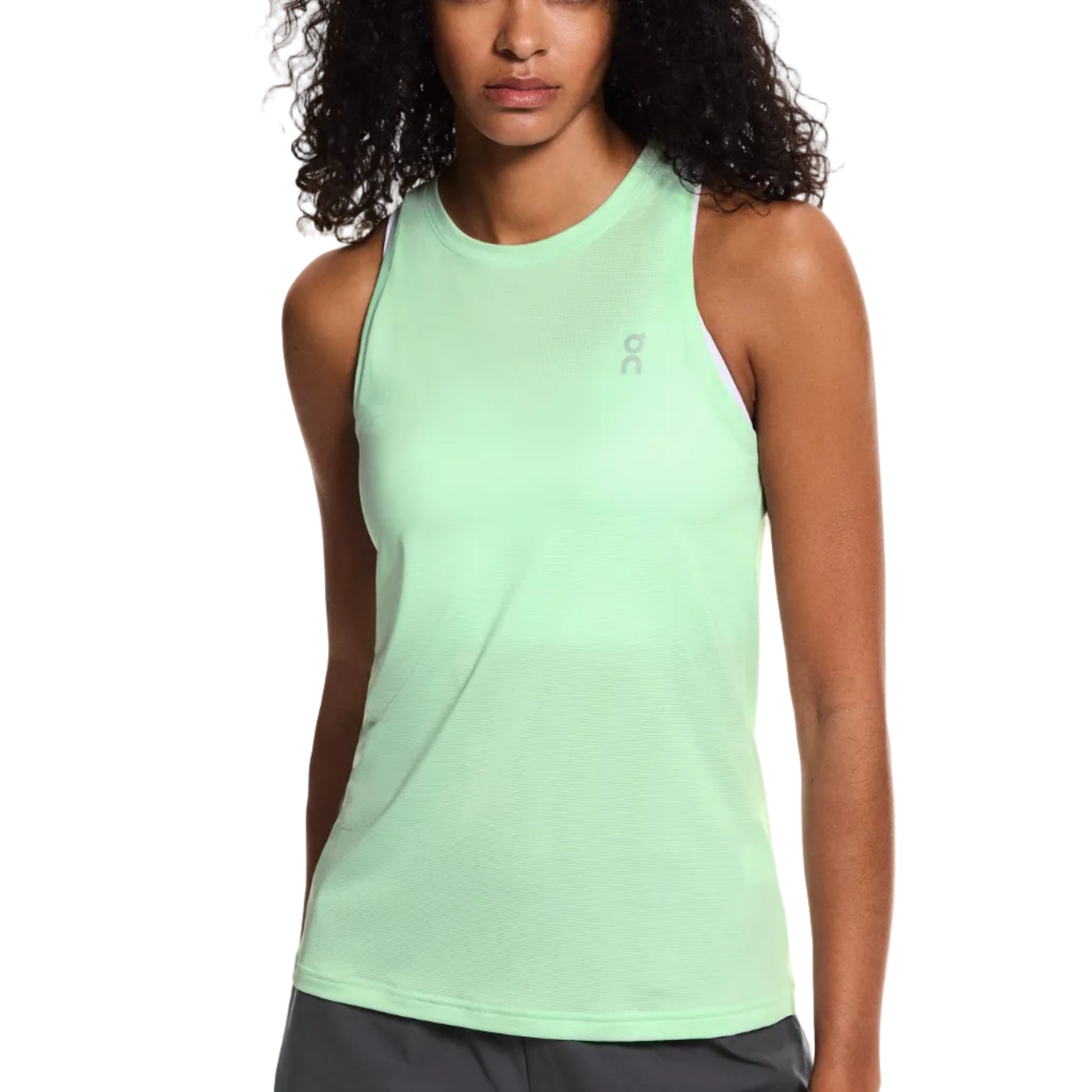Woman wearing a light green tank top with a brand logo on a white background