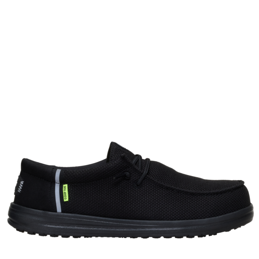 Black slip-on shoe with a small green tag on a white background