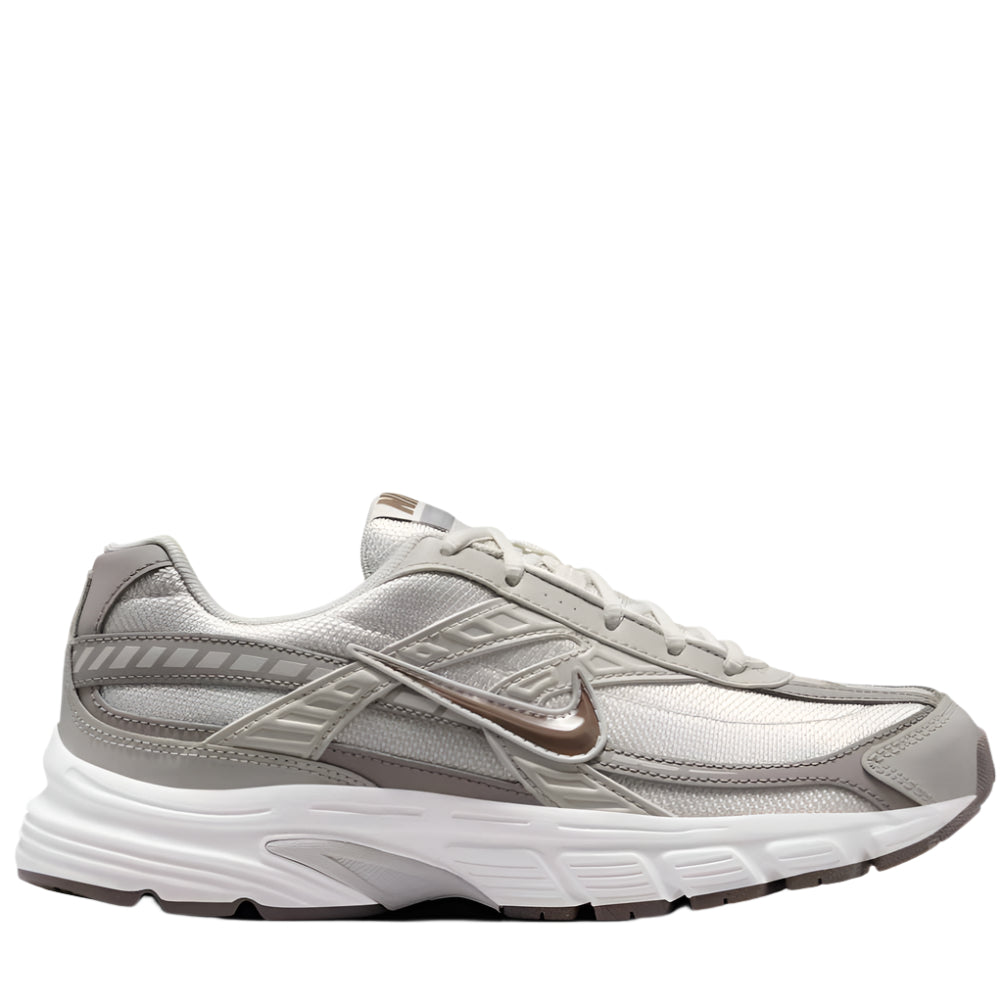 A pair of women's Nike Initiator running shoes in gray color with cushioning and support features visible.