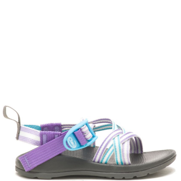 A child's sandal with purple, blue, and gray webbing straps and a black sole.